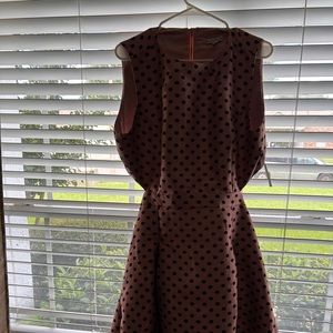Pink and black Polka dot dress with cut out detail on the back.